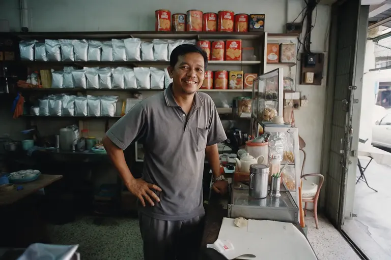 A brand owner in his shophouse store with his own packaged products.